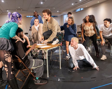 RENT cast members gather around a table