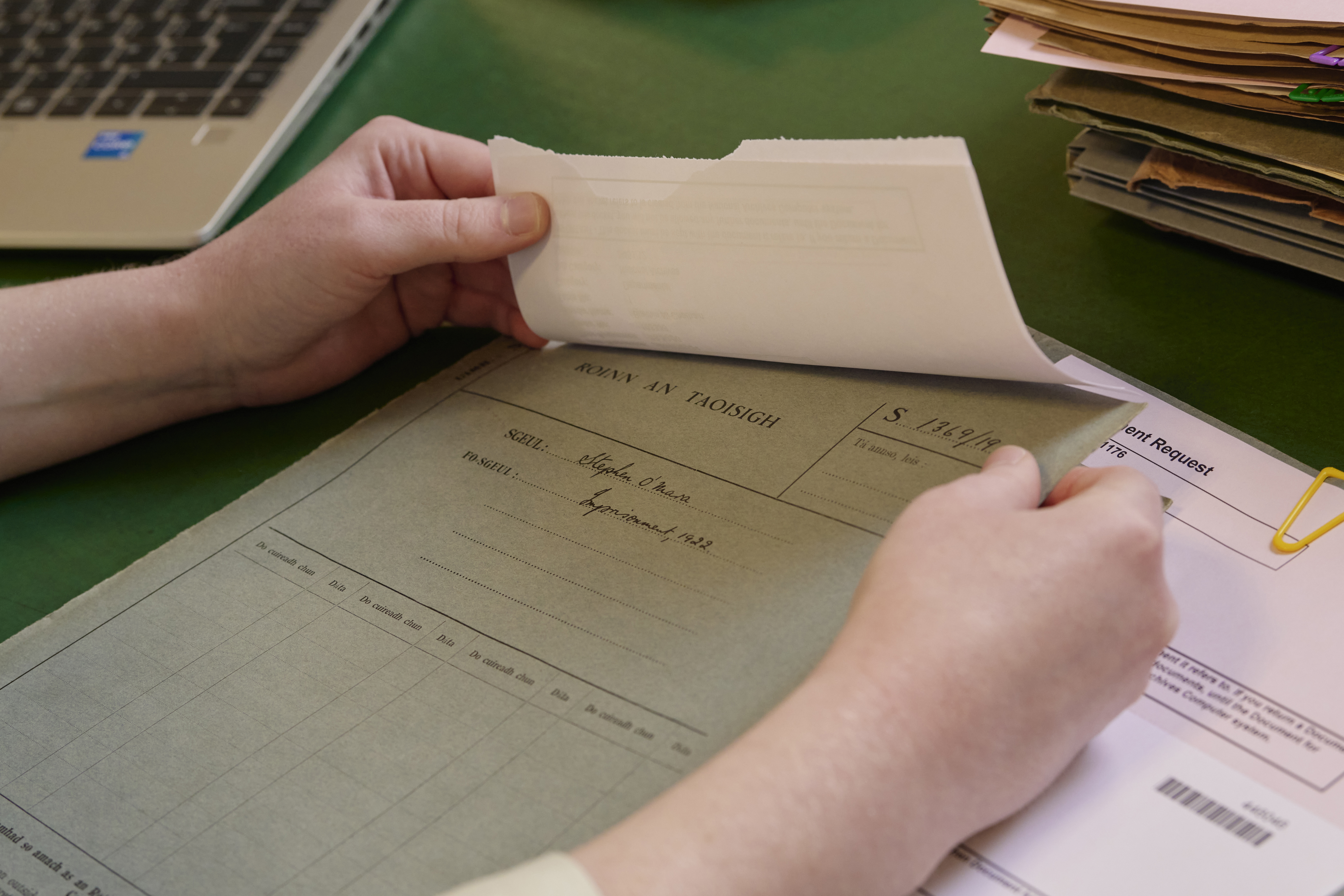A researcher reading some documents related to the Department of the Taoisigh