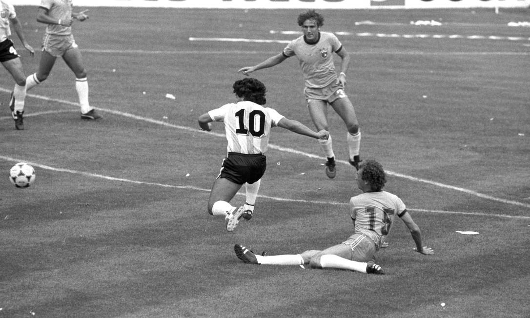 Maradona tenta passar pelo volante brasileiro Falcão na derrota de 3 a 1 para o Brasil, no Estádio Sarriá, em Barcelona — Foto: Erno Schneider/Agência O Globo